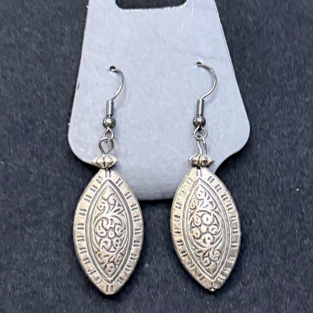 Bali-style dangle earrings feat. intricate filigree patterns on marquise shape